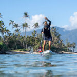Bernd Roediger on an Infinity BlackFish paddle board on Maui with a Black Project PowerGrip SUP Handle.