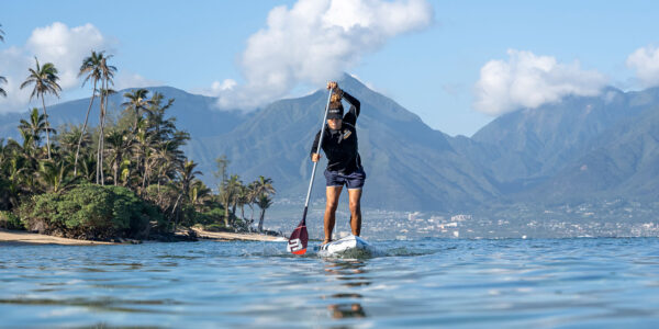 Bernd Roediger stand up paddle boarding on a Infinity Blackfish with a Black Project Hydro SprintX SUP race paddle.