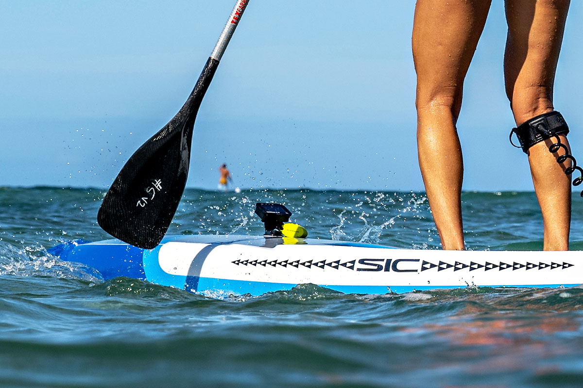 Seychelle standup paddling with a Black Project Hydro SprintX SUP race paddle prototype.