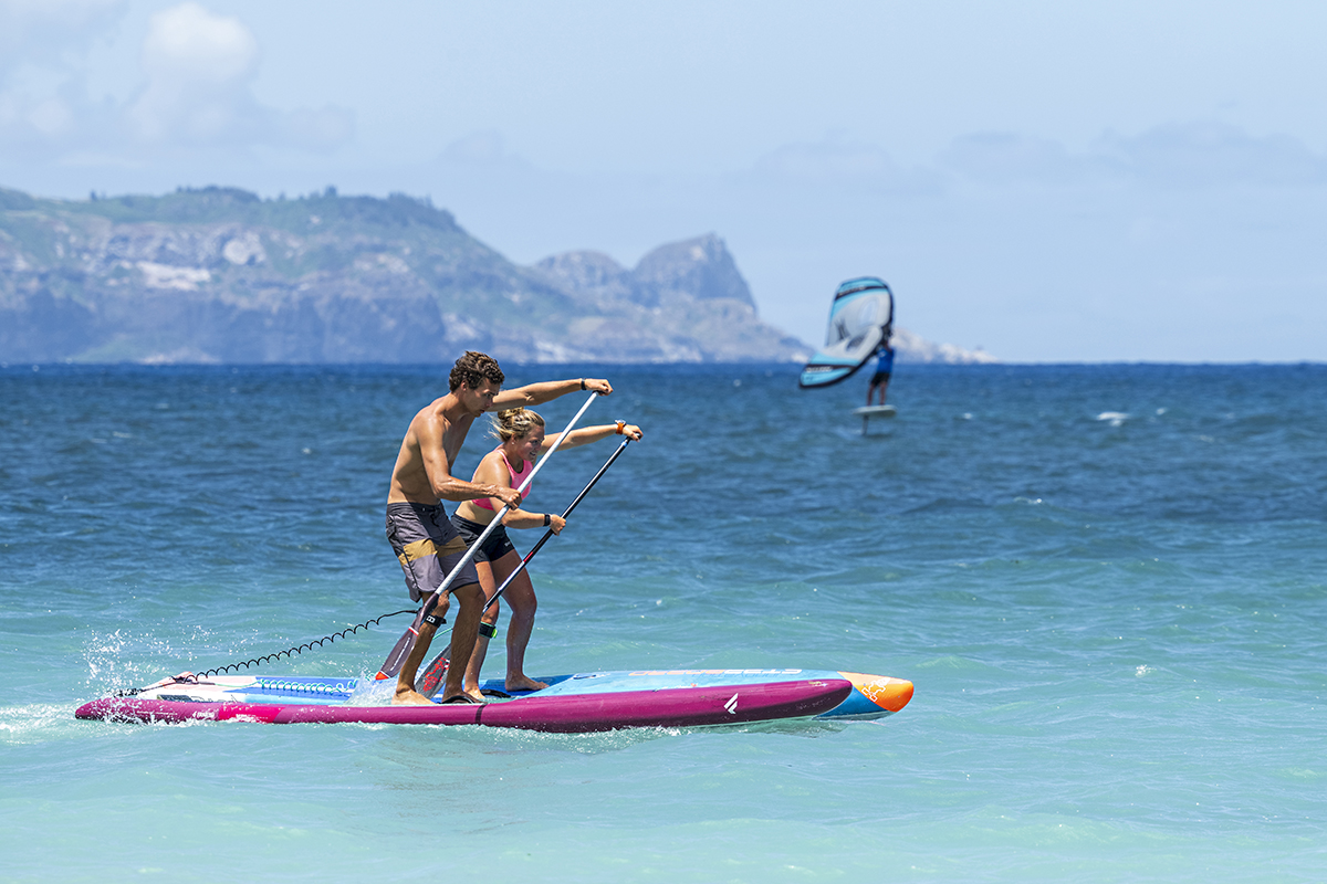 Arthur Arutkin and Fiona Wylde paddleboarding with Ray v2 SUP fin for tracking and stability.